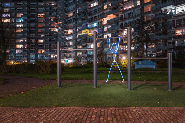 Light painting in the park - human silhouette on the horizontal bar — Stock Image Light Painting Park Human Silhouette Horizontal Bar Royalty Free Stock Photos