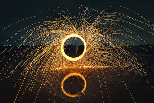 Turning steel wool on fire in the air above the water — Stock Image Turning Steel Wool Fire Air Water Stock Picture