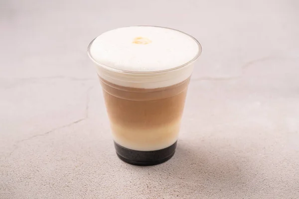 Ice latte. Coffee and Milk on to go package. Studio shoot on gray background.