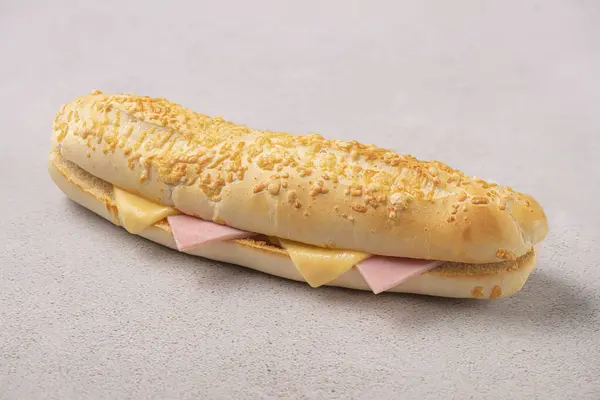 Baguette with cheese and Ham. Subway style sandwich. Studio shoot on gray background.