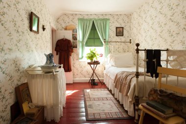 Typical furnishing of late XIX century, room interior of famous House of Green Gables, home of Anne, in Cavendish, Prince Edward Island, Canada clipart