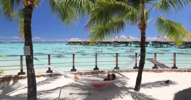 Travel Luxury Vacation Woman Relaxing Sleeping Hammock Luxury Resort Overwater — Stockvideo