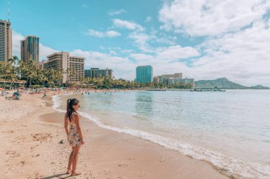 Waikiki beach travel lifestyle. Tourist woman walking in Honolulu, Hawaii during winter holidays. Summer vacation destination. clipart