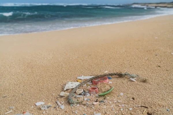 Beach cleanup of plastic fragments pollution from the ocean. Marine debris in Hawaii.