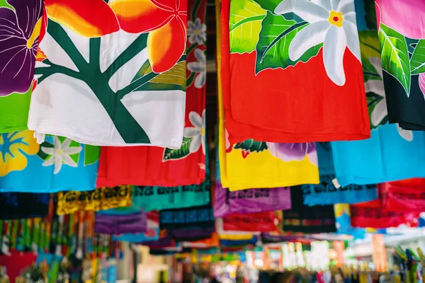 法属波利尼西亚塔希提帕皮提市市场的Sarong裙子店 五颜六色的服装包装挂着作为手工旅游纪念品出售 免版税图库照片
