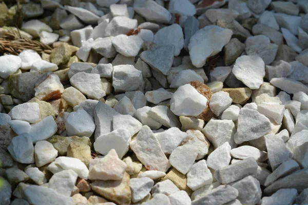 White shiny decorative stones. Background of white stones.