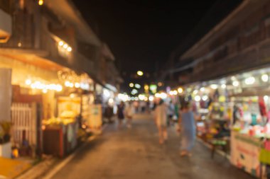 Yürüyen pazarda bulanık bir odak noktası var. Ampulün turuncu bir kabı var..