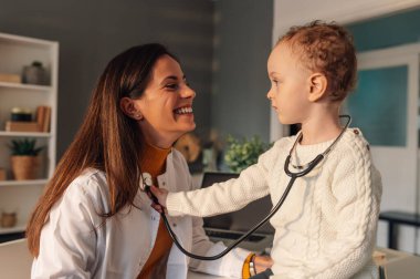 Şakacı küçük bir hasta doktoruyla birlikte doktorun ofisinde oturuyor ve ciğerlerini steteskopla inceliyor. Küçük bir çocuk randevusu ve ziyareti sırasında doktoruyla oynuyor..