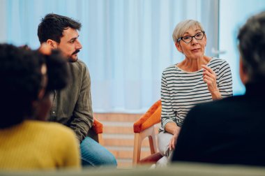 Çeşitli insanlar grup terapi toplantılarında bağımlılık ve zihinsel sağlık sorunlarını tartışıyor. Hastalar zihinsel sağlık sorunları hakkında konuşuyorlar ve destek arıyorlar. Boşluğu kopyala.