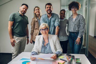 Modern bir şirketin toplantı odasında dizüstü bilgisayarın etrafında çalışan çeşitli yaratıcı iş adamları. Beyin fırtınası konsepti. Ofis hayatı. Çok ırklı meslektaşlar.