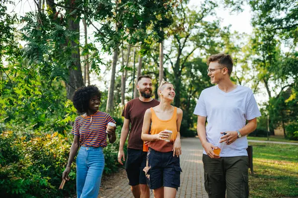 stock image Two interracial couples having fun on double date in nature. Hippie couples having talking, flirting and having fun together. Young people spending sunny day in nature on double date. Relationship.