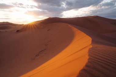 Sahra Fas: Görkemli çöl genişliği, altın kum tepeleri, büyüleyici manzaralar ve yıldızlı çöl gökyüzünün altında büyüleyici bir deneyim sunuyor. Yüksek kalite fotoğraf