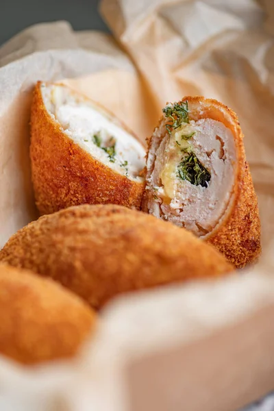 Close up Chicken Kiev Cutlets. Breaded Chicken Kiev breast stuffed with butter, garlic and herb. Chicken patties cakes fried in breadcrumbs.