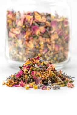tea pile of lavender, chamomile, rose petals, mint on white background. Close up.