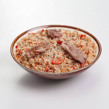 Fried rice with beef and vegetables on white background. Traditional chinese food - fried rice with egg and beef in ceramic bowl. Bowl with fried rice beef