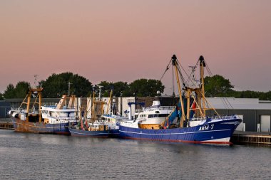 Vlissingen, Netherlands - August 2022: Trawlers moored in the town's commercial dock. clipart