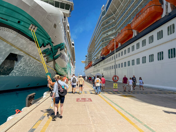 Kusadasi, Turkey - May 2022: People returning to their cruise ships moored in the town's port