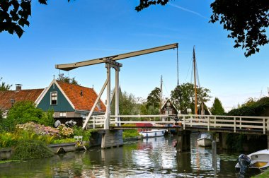 Edam, Netherlands - August 2022: Old wooden lifting bridge over one of the canals in the centre of the Dutch town of Edam, which is famous for its cheese.