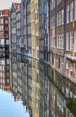 Amsterdam, Netherlands - August 2022: Old buldings on the side of a canal in the city centre