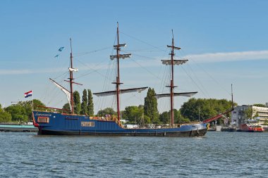 Amsterdam, Netherlands - August 2022: Old sailing ship on the river which runs near the city centre