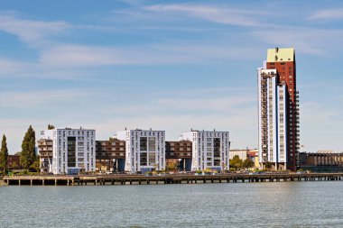 Rotterdam, Nertherlands - August 2022:  Apartment blocks on the riverbank of the Nieuwe Maas river.
