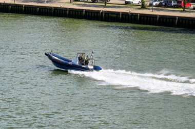 Rotterdam, Nertherlands - August 2022:  Police rigid inflatable boat at speed on the Nieuwe Maas river.