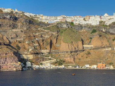 Santorini, Greece, - June 2022: Scenic landscape view of the town of Fira on top of the island's tall cliffs