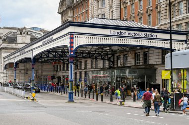 London, UK - August 2022: People entering and leaving London Victoria railway station clipart