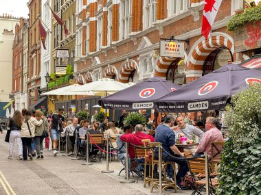 London, UK - August 2022: People dining on outside tables in a restaurant in central London