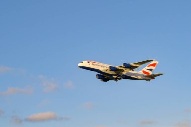 London, United Kingdom - February 2023:  British Airways Airbus A380 jet (registration G-XLED) climbing after take off against a clear blue sky
