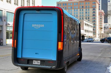 Austin, Texas - February 2023: Rear view of an electric delivery van operated by Amazon Prime on a street in the city centre