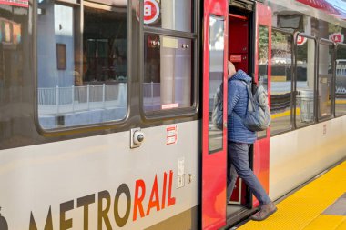 Austin, Texas, USA - February 2023: Person getting on a train at the Metrorail Downtown railway station in the city centre