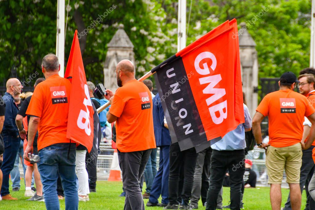 London, England, UK - 28 June 2023: People wearing t-shirts and holding flags with the logo of the GMB trade union