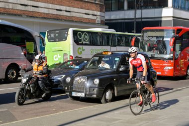 Londra, İngiltere, İngiltere - 22 Ağustos 2023: Londra 'nın orta kesimindeki Oxford Caddesi' nde kaldırımda bisiklet süren bisikletçi.