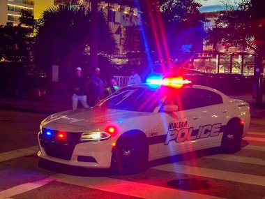 Miami, Florida, USA - 2 December 2023: Police patrol cruiser 4x4 vehicle with flashing lights operated by the Hialeah police department in Miami at night clipart