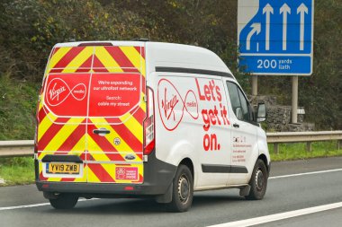 Newport, Wales, UK - 29 November 2023: Van operated by Virgin Media driving on the M4 motorway clipart