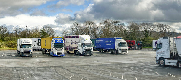 Strensham, Worcestershire, UK - 17 March 2024: Panoramic view of articulated lorries parked at the Strensham M5 motorway service station