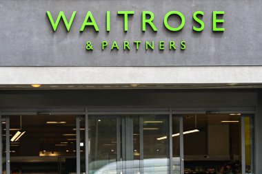 London, England, UK - 27 June 2023: Entrance to a branch of Waitrose supermarket in central London clipart