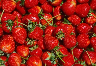 Close up view of a box of ripe strawberries on a market stall clipart