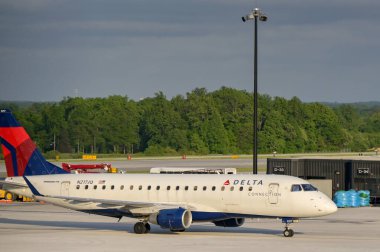 Baltimore, Maryland, USA - 3 May 2024: Embraer 170 commuter jet (registration N217JQ) operated by Delta Air Lines Delta Connection arriving at Baltimore Thurgood Marshall Airport clipart