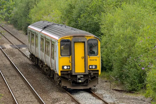 stock image Pontyclun, Wales, UK. - 31 July 2024:  Class 150 diesel commuter train operated by Transport for Wales approaching the railway station in the village of Pontyclun in south Wales.