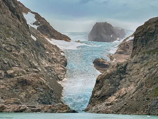 stock image Glacier flowing to the water's edge of one of the fjords inPrince Christian Sound in Greenland