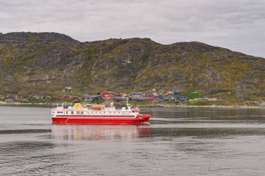 Qaqortoq, Greenland - 28 August 2024: Ferry Sarfaq Ittuk arriving at the remote town of Qaqortoq in southern Greenland clipart