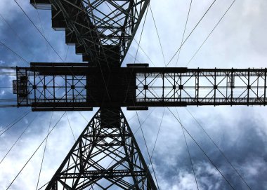 Newport, Wales, UK - 18 September 2017:  View looking up to the heavy steel frame of the Newport Transporter Bridge over the River Usk in south Wales clipart