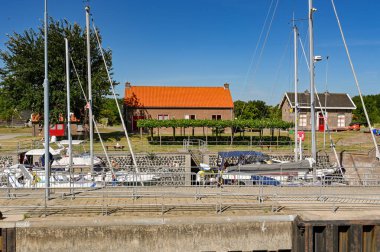 Veere, Zeeland, The Netherlands - 10 August 2022: Boats and yachts in the canal lock in the town of Veere. clipart