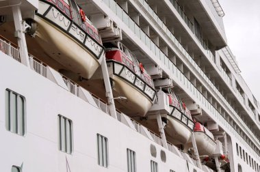 Isafjordur, Iceland - 25 August 2024: Lifeboats on the side of the NCL Norwegian Star cruise ship. clipart