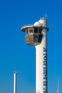 Le Havre, France, Europe - 16 January 2025: Shipping control tower for the Port of Le Havre isolated against a clear blue sky clipart