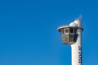 Le Havre, France, Europe - 16 January 2025: Shipping control tower for the harbour of the Port of Le Havre isolated against a clear blue sky clipart