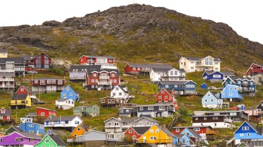 Qaqortoq, Greenland - 28 August 2024: Houses on the side of the hill overlooking the harbour in the remote town of Qaqortoq. clipart