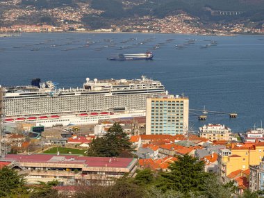 Vigo, Spain - 14 January 2025: Cruise ship Norwegian Bliss in the port of Vigo seen from the the El Castro Castle on Castro Mountain overlooking the city of Vigo. clipart